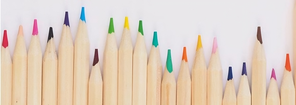 numerous colored pencils lined up next to each other