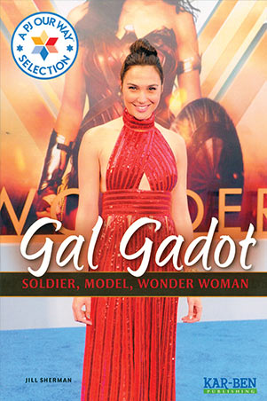 Gal Gadot standing in front of a Wonder Woman poster